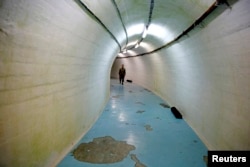 FILE - A member of the Armed Forces of Bosnia and Herzegovina walks through a tunnel in Josip Broz Tito's underground secret bunker (ARK) in Konjic, Oct. 16, 2014. In the early 1950s Tito ordered the building of the secret bunker to safeguard the country's ruling class in case of a nuclear attack.
