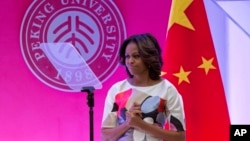U.S. first lady Michelle Obama reacts after she gave a speech at Stanford Center in the Peking University in Beijing, China, March 22, 2014.