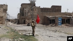 FILE - A Pakistani army soldier stands guard in Miran Shah bazaar, July 9, 2014. Pakistan's military said Sunday that 95 percent of the tribal people in North Waziristan displaced by military operations against militants had returned to their homes.