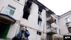 Ukraine -- An elderly man sits in front building destroyed during combat and shelling between Ukrainian forces and pro-Russian militants in eastern city of Donetsk, 13, 2014