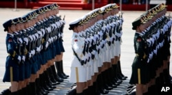 Chinese female military personnel march during a parade commemorating the 70th anniversary of Japan's surrender during World War II held in front of Tiananmen Gate, in Beijing, Thursday, Sept. 3, 2015.