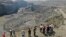 People stand atop a ridge overlooking the scene of a mudslide at a jade gemstone mining site, April 23, 2019, in Hpakant area of Kachin state, northern Myanmar. 