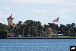 The U.S. flag flies at full height at U.S. President-elect Donald Trump's Mar-a-Lago compound in Palm Beach, Florida, on Jan. 13, 2025, despite federal and state orders that flags be lowered to half-staff following the death of former President Jimmy Carter.