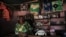 A Congolese woman stands inside her cosmetic shop in Bunagana near the Uganda-Democratic Republic of Congo border, July 9, 2012. 