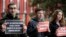 FILE - Protesters hold banners outside the building where Jeremy Corbyn, Leader of Britain's opposition Labor Party, attended the launch of Labor's General Election manifesto, at Birmingham City University, England, Nov. 21, 2019. 