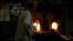 A glass-worker heats glass in a methane powered ovens in a factory in Murano island, Venice, Italy, Oct. 7, 2021.