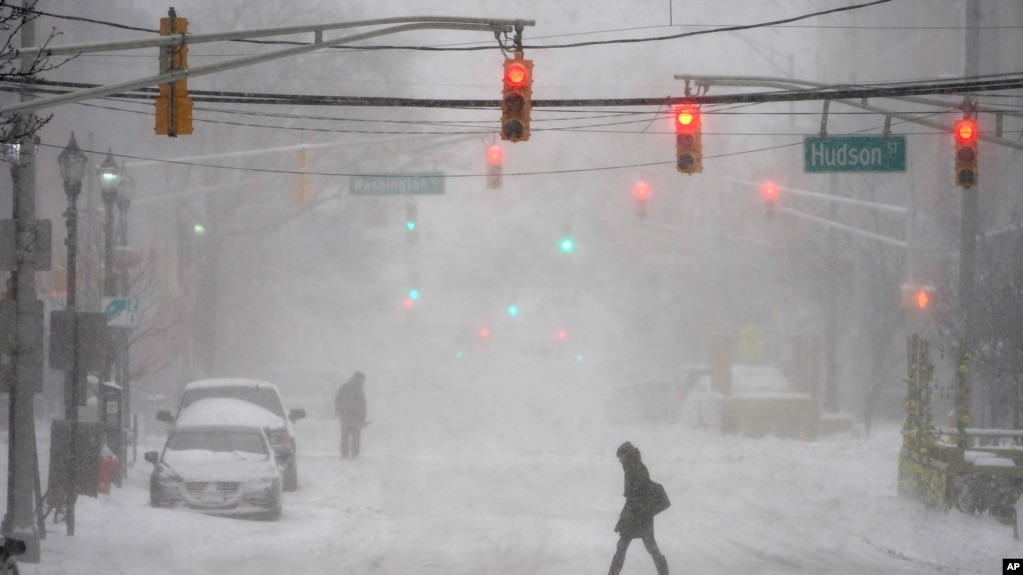 Pedestrians make their way through heavy snow and wind in Hoboken, N.J., Monday, Feb. 1, 2021. (AP Photo/Seth Wenig)