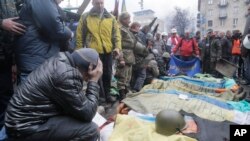 Para demonstran berdoa bagi rekan-rekan mereka yang tewas dalam penembakan di Lapangan Kemerdekaan di Kyiv, Ukraina (foto: dok). 