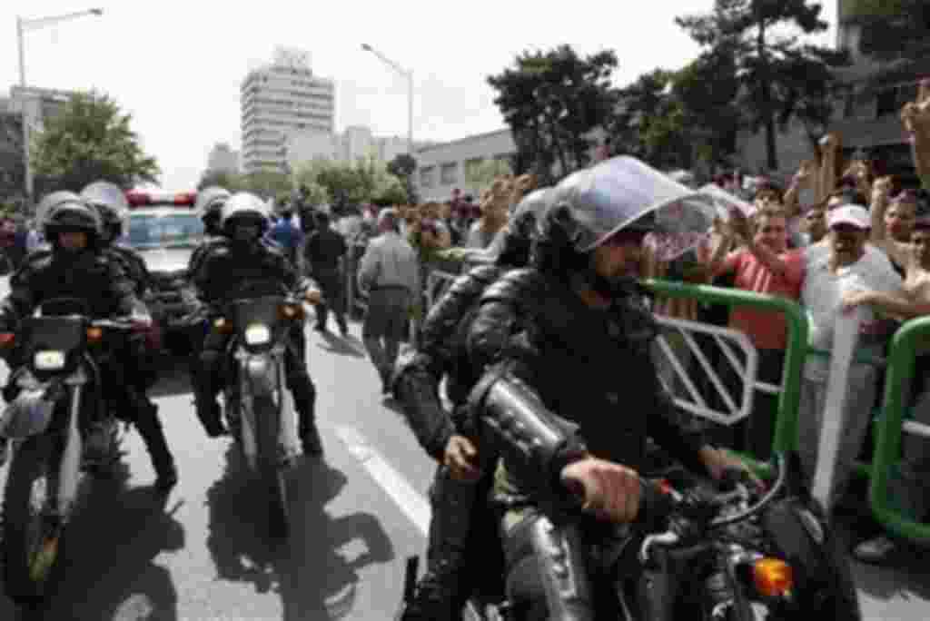 Iranian anti-riot police officers on motorcycles patrol a mass protest over the June 12 disputed presidential election, in Tehran, Iran in this Monday June 15, 2009 photo. Iran's supreme leader has imposed his will on the streets with security forces that