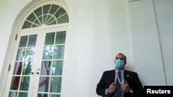 Seorang anggota pasukan pengamanan presiden berjaga di West Wing depan Ruang Kabinet di mana Presiden Donald Trump menggelar konferensi pers, di Gedung Putih, Washington, 11 Mei 2020. (Foto: Reuters)