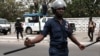 FILE - Police officers stand guard as protesters march in Ghana's capital Accra against the expansion of its defence cooperation with the United States, Ghana, March 28, 2018. 