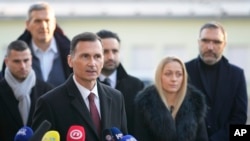 Dragan Primorac, the candidate of the ruling Croatian Democratic Union (HDZ) speaks to the media after casting his ballot during a presidential election at a polling station in Zagreb, Dec. 29, 2024.