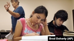 University of Texas-Southmost College students, Jessica Vargas, center, and Patrick Flores, right, work on a writing assignment.