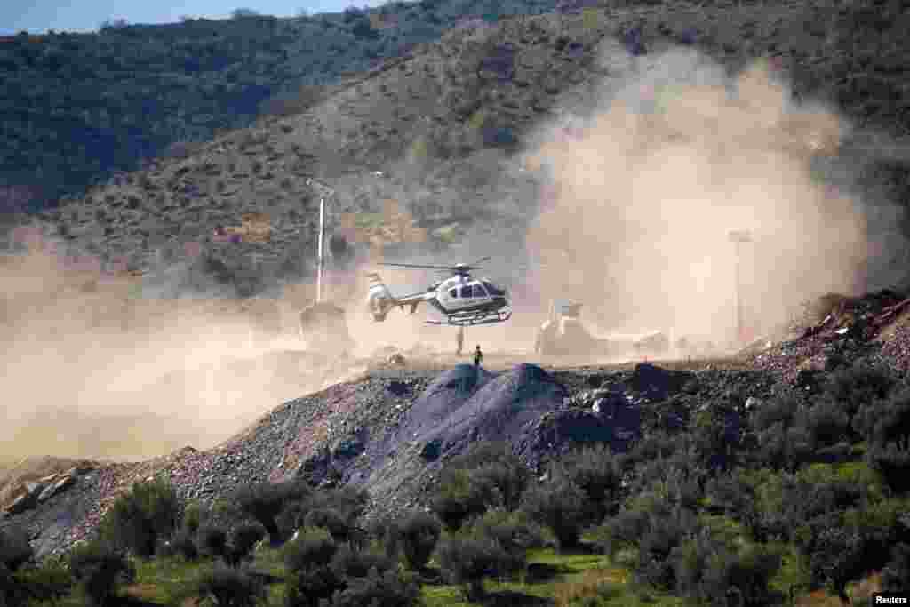 A Spanish Civil Guard helicopter carrying boxes with explosives picked in Sevilla lands at the area where Julen, a 2-year-old Spanish boy, fell into a deep well 12 days ago when the family was taking a walk through a private estate, in Totalan, southern Spain.