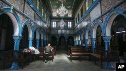 A Jewish Tunisian rests inside the Ghriba synagogue, one the oldest Jewish monuments built in Africa more than 2,500 years ago, on the resort island of Djerba, south of Tunis, Oct. 28, 2015.