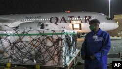 The first arrival of COVID-19 vaccines to Kenya is offloaded from a Qatar Airways flight at Jomo Kenyatta International Airport in Nairobi, Kenya, March 3, 2021.