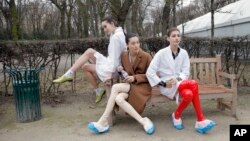 FILE - Models take a rest backstage after the Christian Dior's Spring-Summer 2015 Haute Couture fashion collection presented in Paris, Jan. 26, 2015. Two of France's biggest luxury conglomerates, LVMH and Kering, have joined forces to establish a charter to ban size zero models. 