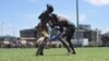 Two wrestlers grapple at the "Wrestling for Peace" tournament at Juba Stadium in South Sudan's capital, April 16, 2016. (J. Patinkin/VOA)