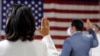 FILE- People take the oath of citizenship during a naturalization ceremony at the U.S. Citizenship and Immigration Service's Field Office in New York City, July 2, 2020.
