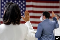 FILE - People take the oath of citizenship during a naturalization ceremony at the U.S. Citizenship and Immigration Service's Field Office in New York City, July 2, 2020.