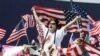 FILE — A man waves an American flag during a during a rally in Atlanta, Georgia.