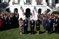U.S. President Donald Trump stands with first lady Melania Trump, Vice President Mike Pence and his wife Karen (R) during a moment of silence in the wake of the the mass shooting in Las Vegas at the White House in Washington, Oct. 2, 2017.