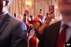 People cheer as former President Donald Trump announces a third run for president as he speaks at Mar-a-Lago in Palm Beach, Florida, Nov. 15, 2022.