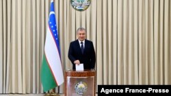 Uzbek President Shavkat Mirziyoyev casts his ballot at a polling station during the presidential election in Tashkent, Oct. 24, 2021.