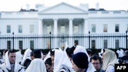 FILE —People pray on Pennsylvania Avenue in front of the White House before a rally supporting Israel during its conflict with Hamas November 14, 2023, in Washington, DC.