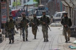 Indian paramilitary soldiers are seen after gun battle with suspected rebels ended in Srinagar, Indian controlled Kashmir, May 19, 2020.