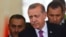 Turkish President Tayyip Erdogan (C) looks on after arriving at Esenboga Airport, in Ankara, June 8, 2015. 