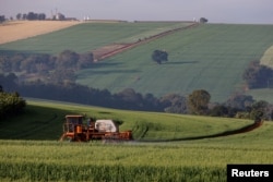 FILE PHOTO: A tractor sprays pesticides on wheat crops to be harvested this year, in Arapongas, Parana, Brazil July 6, 2022. (REUTERS/Rodolfo Buhrer/File Photo)