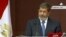 In this image made from a live broadcast on Egyptian State Television, Egyptian President Mohammed Morsi speaks to the constituent assembly in Cairo, Egypt, Dec. 1, 2012.