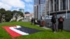 Protesters against the Treaty Principles Bill stand by a Maori sovereignty flag outside Parliament in Wellington, New Zealand, Nov. 14, 2024