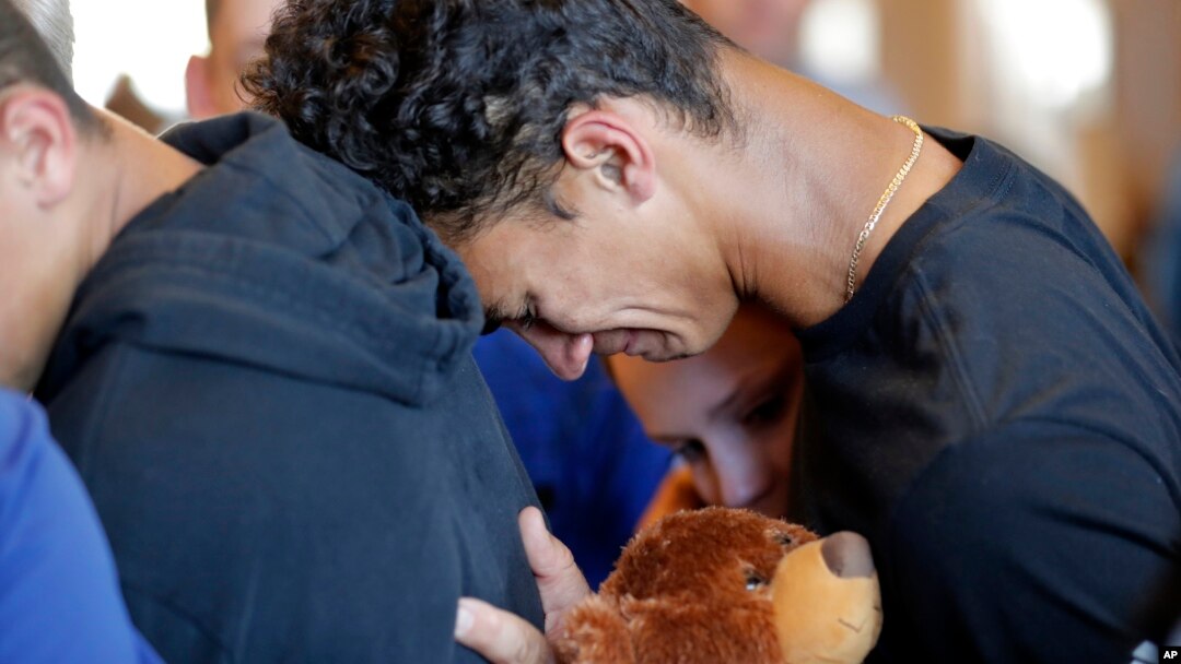 Austin Burden, 17, cries on the shoulder of a friend after a vigil at the Parkland Baptist Church, for the victims of the Wednesday shooting at Marjory Stoneman Douglas High School, in Parkland, Fla., Feb. 15, 2018. 