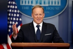 FILE - Then-White House press secretary Sean Spicer smiles as he answers a question during a briefing at the White House, in Washington, June 20, 2017.