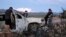 FILE - Relatives of slain members of Mexican American families belonging to Mormon communities observe the burned wreckage of a vehicle where some of their relatives were killed, in Bavispe, Sonora state, Mexico, Nov. 5, 2019.