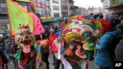 FILE - A pair of lion dancers from the Tai Pun Residents Association perform during a Lunar New Year celebration, in New York's Chinatown neighborhood, Feb. 8, 2016.