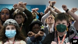 Activists demonstrate in silence protesting a draft of a proposed deal for curbing climate change at the COP29 U.N. Climate Summit in Baku, Azerbaijan, Nov. 22, 2024.