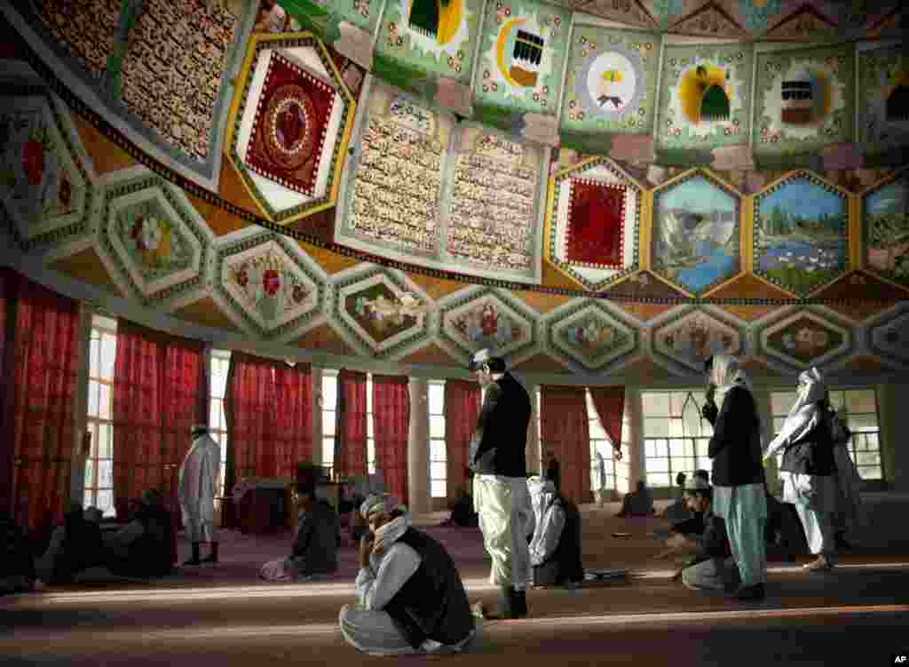 Afghan men gather for prayers inside the Eid Gah mosque, one of the country's largest mosques in Kandahar, southern Afghanistan.