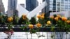 Flowers are seen placed into the groves of inscribed names of the victims of the 9/11 terrorist attacks, at the National September 11 Memorial and Museum, Sept. 11, 2020, in New York City.