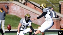 Vanderbilt's Sarah Fuller kicks off as Ryan McCord holds to start the second half of an NCAA college football game against Missouri, Nov. 28, 2020, in Columbia, Mo.