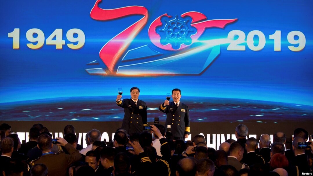 Vice Admiral Shen Jinlong, commander of the Chinese People's Liberation Army (PLA) Navy, and Vice Admiral Qin Shengxiang, political commissar of the PLA Navy, give a toast at a welcome reception for the commemoration of the 70th anniversary of the foundin