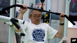 Toshiyuki Honma, 70, uses a lat pulldown machine as he works out at the Fukagawa Sports Center in Tokyo, Wednesday, June 12, 2024. If you are getting up there in years, weight-resistance training might deliver unexpected benefits. (AP Photo/Hiro Komae)