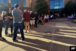 Voters line up outside the Bucks County Administration Building during early voting in the general election, Nov. 1, 2024, in Doylestown, Pennsylvania