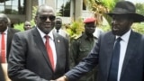 FILE - Riek Machar, left, and President Salva Kiir shake hands following the first meeting of a new transitional coalition government, in Juba, South Sudan, April 29, 2016. 