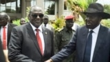 FILE - South Sudan's then-First Vice President Riek Machar (L) and President Salva Kiir (R) shake hands following the first meeting of a new transitional coalition government, in the capital Juba, South Sudan, April 29, 2016. 