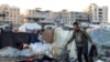 People inspect the site of reported Israeli bombardment on tents sheltering Palestinians displaced from Beit Lahia at a camp in Khan Yunis in the southern Gaza Strip on Dec. 25, 2024.