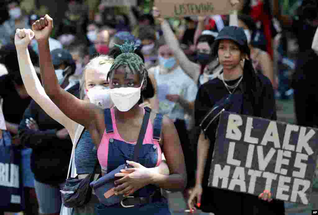 Young women take part in a Black Lives Matter anti-racism protest rally in Berlin, Germany, June 27, 2020.