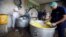 Cooks pack food at a charity kitchen that gives free food rations for the poor, in Sanaa, Yemen, April 20, 2018.